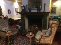 high backed chairs in front of ornate open fireplace